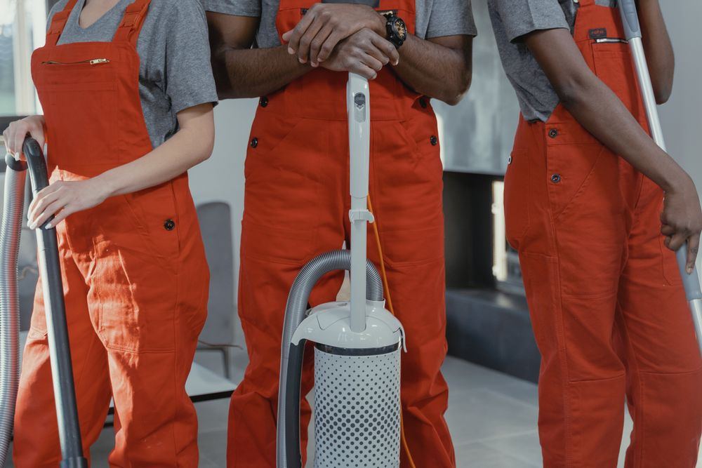Cleaning team members holding professional equipment during a cleanup job in Oklahoma