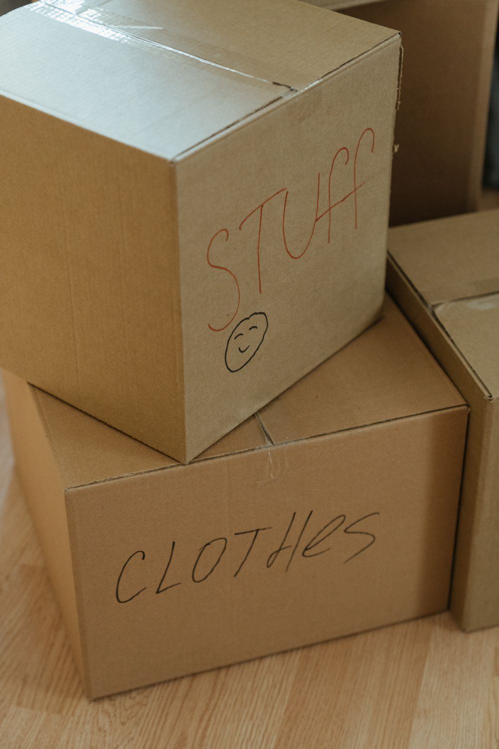 Labeled cardboard boxes stacked during an estate and death cleanout in Oklahoma