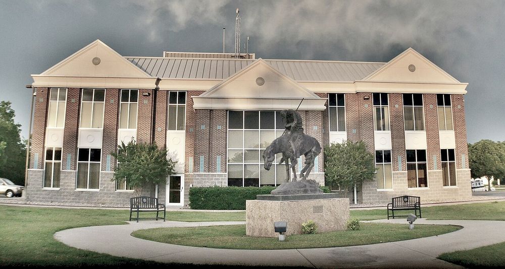 Owasso City Hall in Owasso, Oklahoma, with its front lawn and statue
