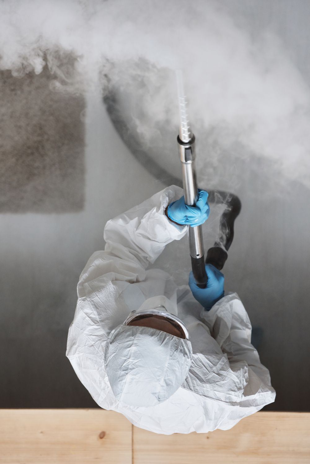 Overhead view of a technician operating a fogger during biohazard odor removal in Oklahoma