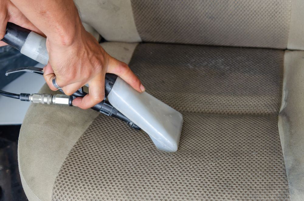 Extraction cleaning of a vehicle seat during vehicle biohazard remediation in Oklahoma